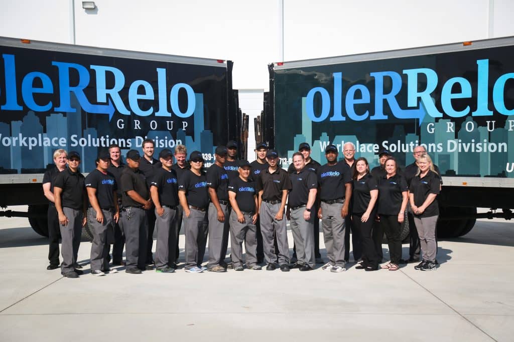 oleRRelo Group Employees Posing in Front of Company Trucks