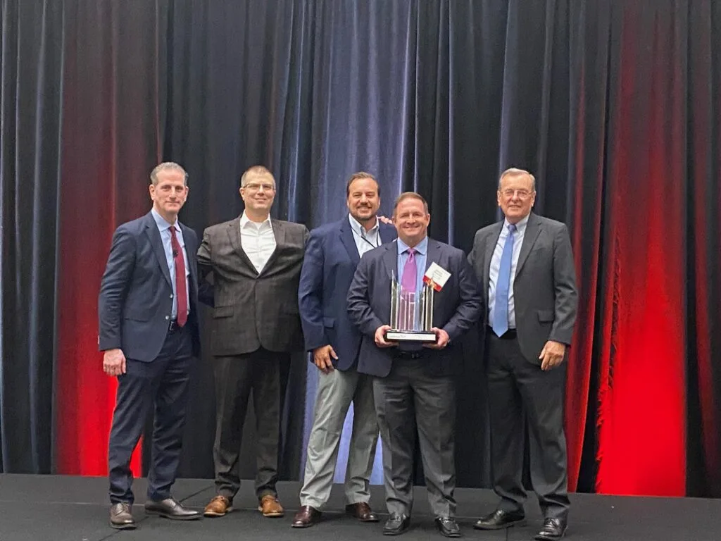 Oler Relo Group accepting UniGroup's 2026 Household Goods Member of the Year award on stage in Dallas
